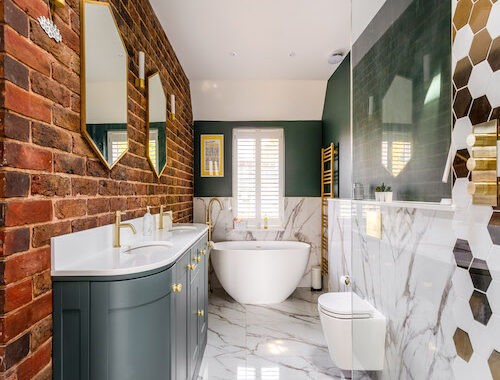 Large_marble_tiled_ensuite_with _large_freestading_Lusso_bath_green_painted_walls_and_large_double_vanity_unit